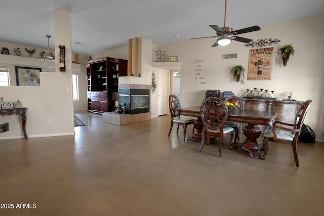 19519 W Minnezona Ave, Litchfield Park, AZ 85340 - dining space with baseboards, a fireplace, a ceiling fan, and visible vents