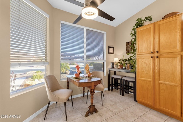 tiled dining area with lofted ceiling and ceiling fan