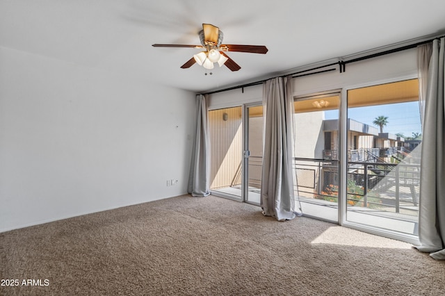 empty room featuring carpet floors and ceiling fan