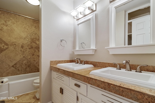 full bathroom with vanity, tile patterned flooring, tiled shower / bath combo, and toilet