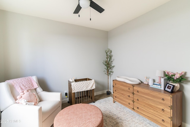 living area with ceiling fan and hardwood / wood-style floors