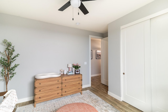 living area with hardwood / wood-style floors and ceiling fan