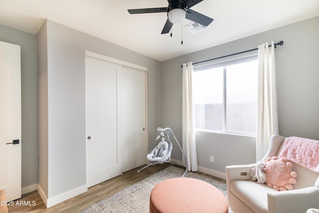 sitting room with ceiling fan and light hardwood / wood-style floors