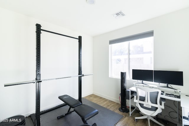 workout area featuring hardwood / wood-style floors