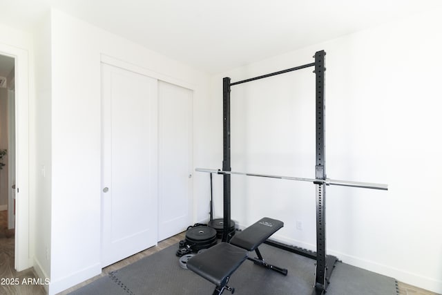 workout area with hardwood / wood-style floors