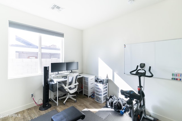 home office with light hardwood / wood-style floors