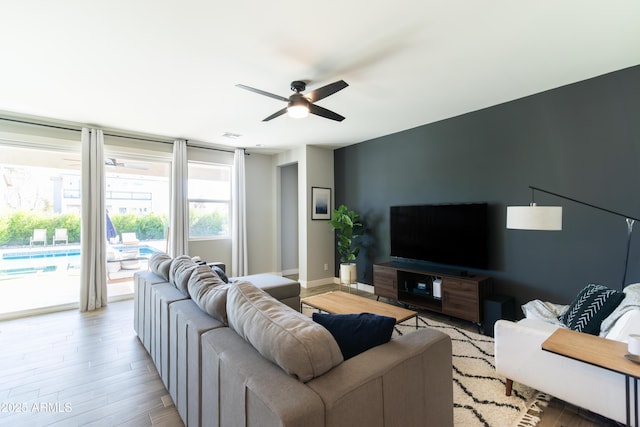 living room with ceiling fan and light hardwood / wood-style flooring