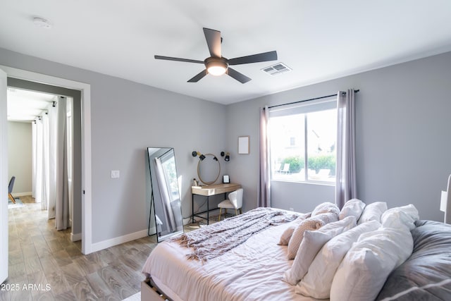 bedroom featuring light hardwood / wood-style floors and ceiling fan