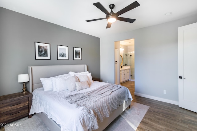 bedroom featuring ceiling fan, dark hardwood / wood-style flooring, and ensuite bath