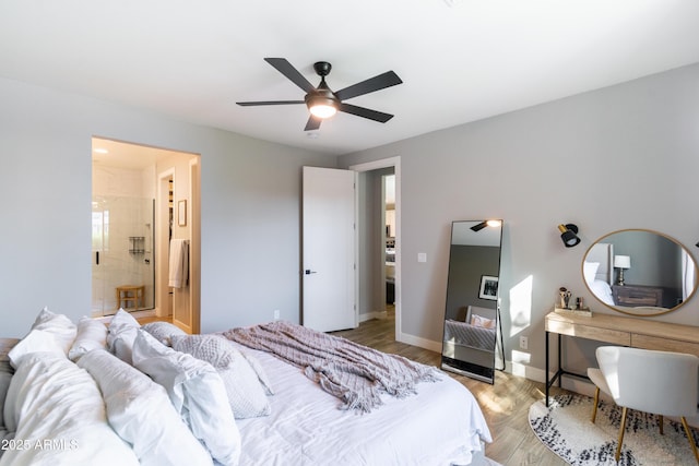 bedroom with ceiling fan, ensuite bath, and light wood-type flooring