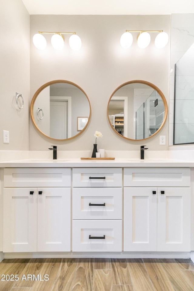 bathroom with vanity, wood-type flooring, and walk in shower