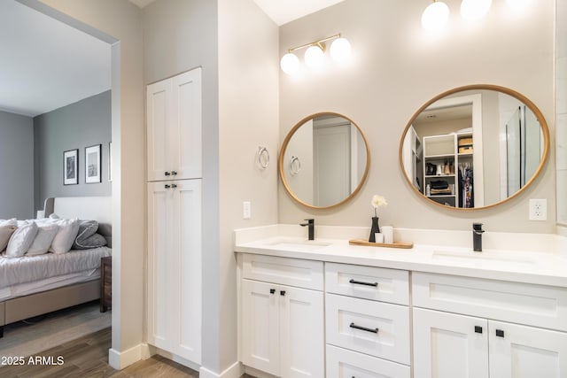 bathroom with vanity and hardwood / wood-style flooring