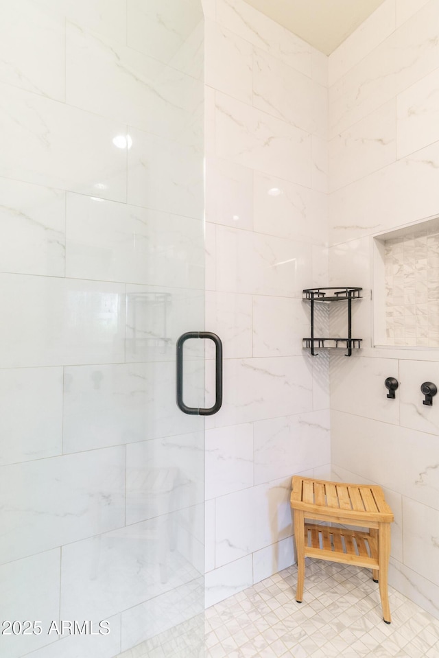 bathroom featuring tile walls and an enclosed shower