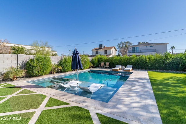 view of swimming pool featuring a yard and a patio area