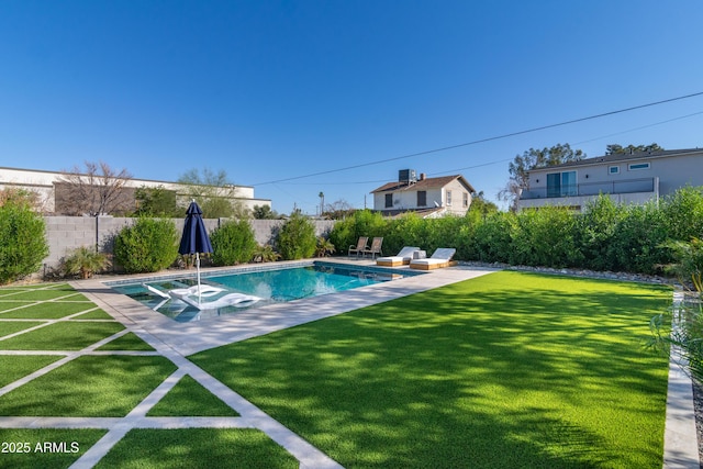 view of swimming pool featuring a lawn and a patio