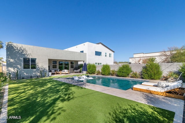 view of pool with a yard and a patio