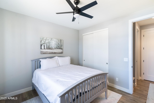 bedroom with hardwood / wood-style floors, ceiling fan, and a closet