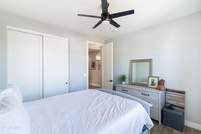 bedroom with dark hardwood / wood-style flooring, a closet, and ceiling fan