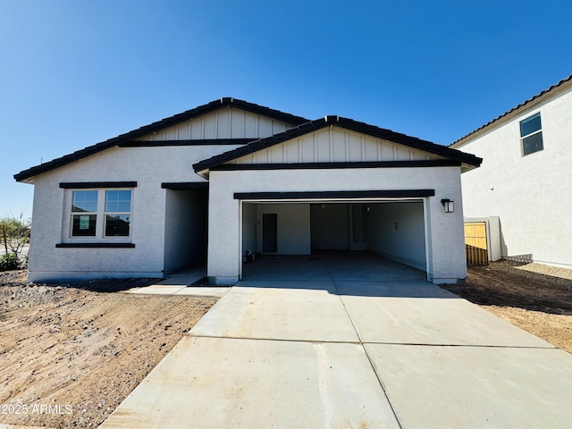 46904 W Coe St, Maricopa, AZ 85139 - ranch-style home featuring an attached garage, driveway, board and batten siding, and stucco siding