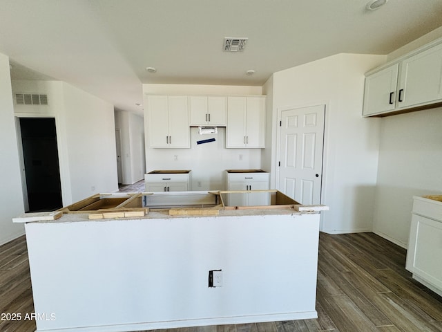46904 W Coe St, Maricopa, AZ 85139 - kitchen featuring a center island, dark wood-style flooring, white cabinets, and baseboards