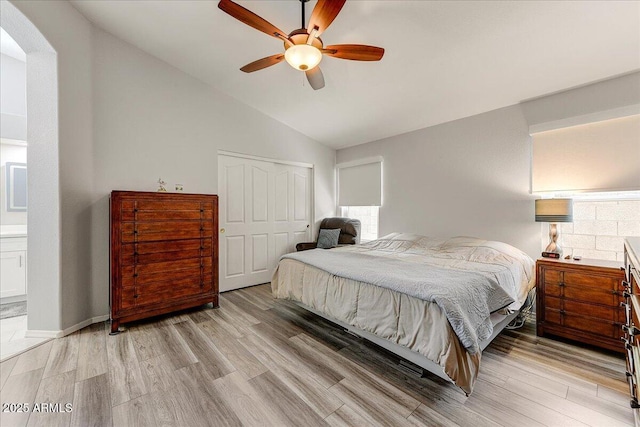 5674 W N Ln, Glendale, AZ 85302 - bedroom featuring arched walkways, light wood finished floors, a closet, and vaulted ceiling