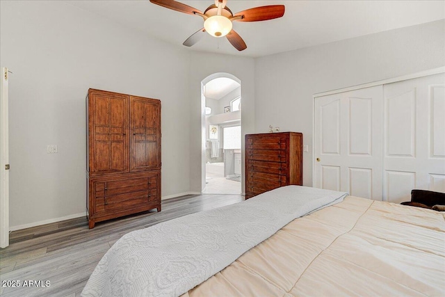 5674 W N Ln, Glendale, AZ 85302 - bedroom with arched walkways, a closet, vaulted ceiling, wood finished floors, and baseboards