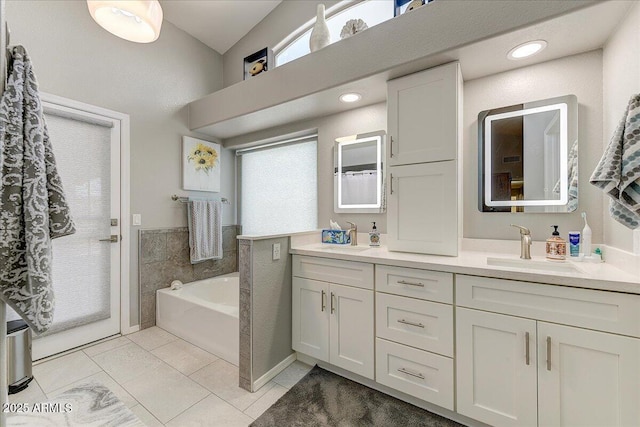 5674 W N Ln, Glendale, AZ 85302 - full bath with a sink, double vanity, tile patterned flooring, a wealth of natural light, and a garden tub