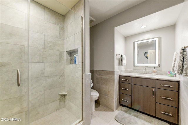 5674 W N Ln, Glendale, AZ 85302 - bathroom featuring a shower stall, vanity, toilet, tile walls, and tile patterned floors