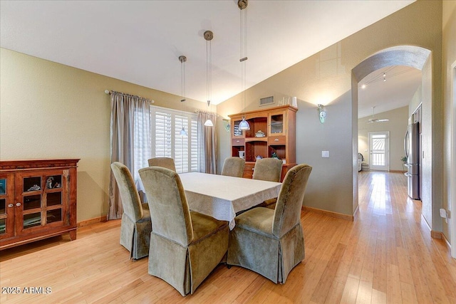 5674 W N Ln, Glendale, AZ 85302 - dining space featuring arched walkways, visible vents, light wood-type flooring, and baseboards