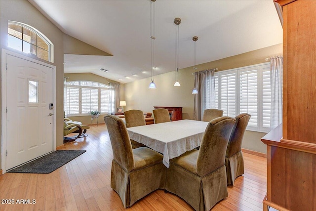 5674 W N Ln, Glendale, AZ 85302 - dining space with visible vents, baseboards, light wood-style floors, and lofted ceiling