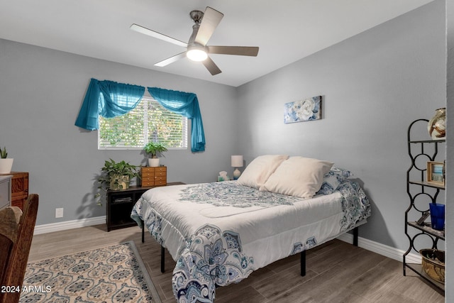 bedroom with ceiling fan and wood-type flooring