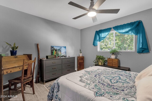 bedroom with ceiling fan and light wood-type flooring