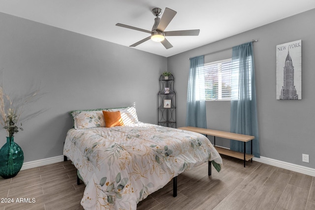 bedroom with ceiling fan and wood-type flooring