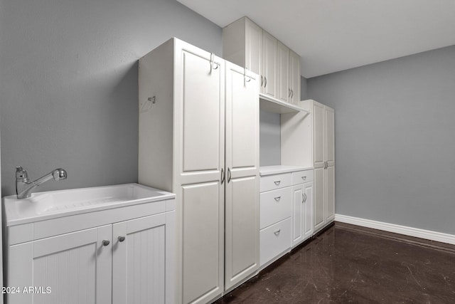 interior space with sink and white cabinets