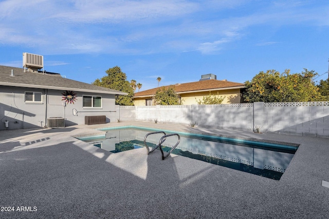 view of pool with central AC and a patio