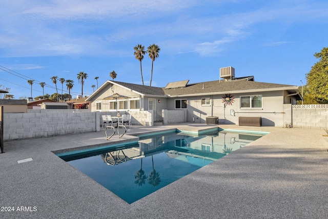 view of swimming pool featuring a patio and cooling unit