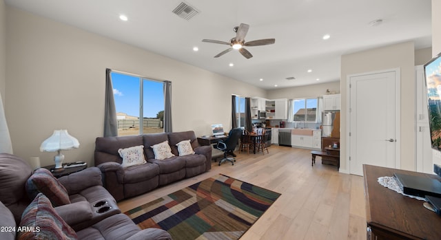 living room with ceiling fan and light wood-type flooring