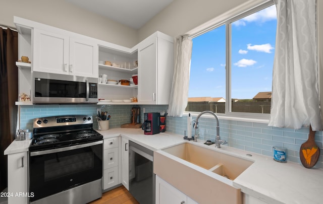 kitchen with white cabinetry, tasteful backsplash, and appliances with stainless steel finishes