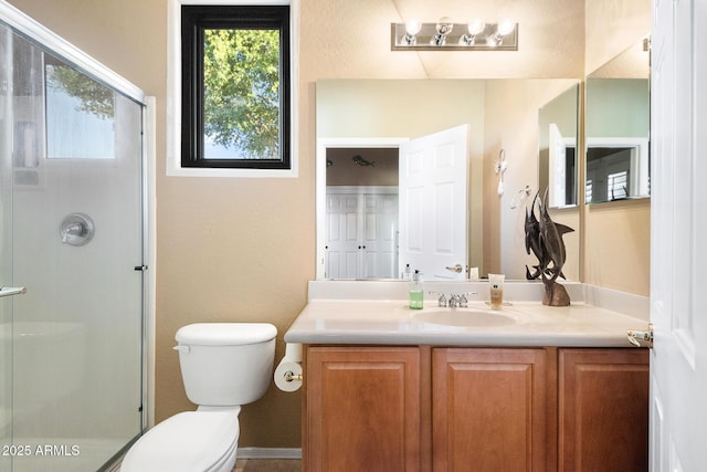 bathroom with vanity, an enclosed shower, and toilet