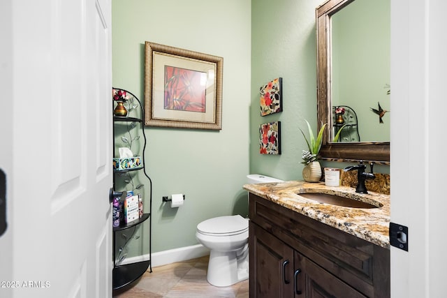 bathroom featuring tile patterned floors, vanity, and toilet