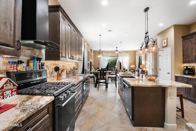 kitchen with a kitchen bar, wall chimney exhaust hood, dark brown cabinetry, stainless steel appliances, and a kitchen island