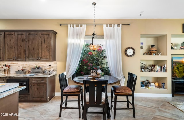 dining space featuring wine cooler and built in features