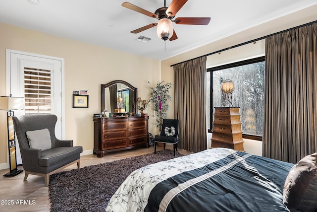 bedroom with ceiling fan and light tile patterned flooring