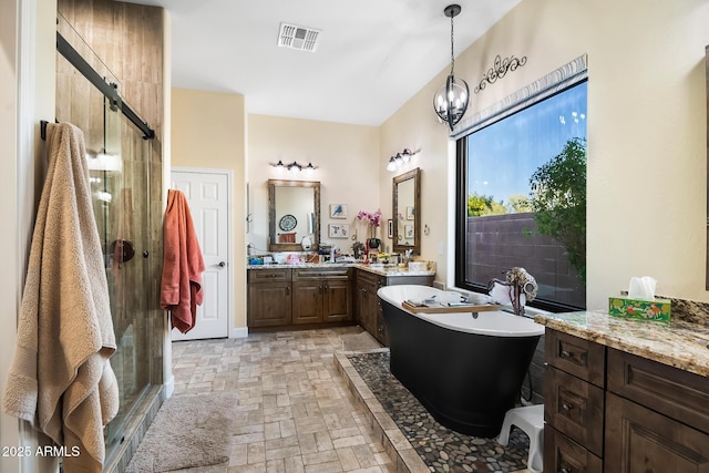 bathroom with shower with separate bathtub, vanity, and a notable chandelier