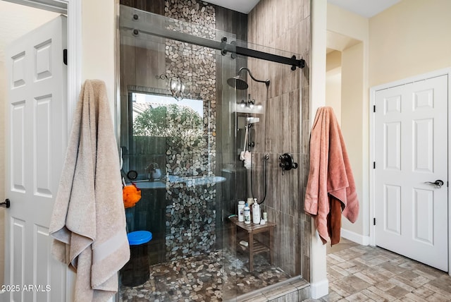 bathroom featuring a shower with door