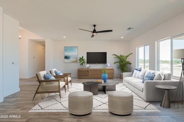 living room with light hardwood / wood-style floors and ceiling fan