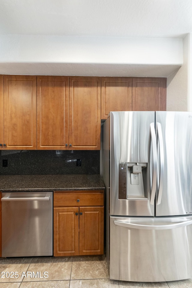 kitchen featuring dark stone countertops and stainless steel appliances