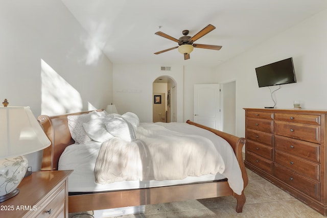 tiled bedroom featuring ceiling fan