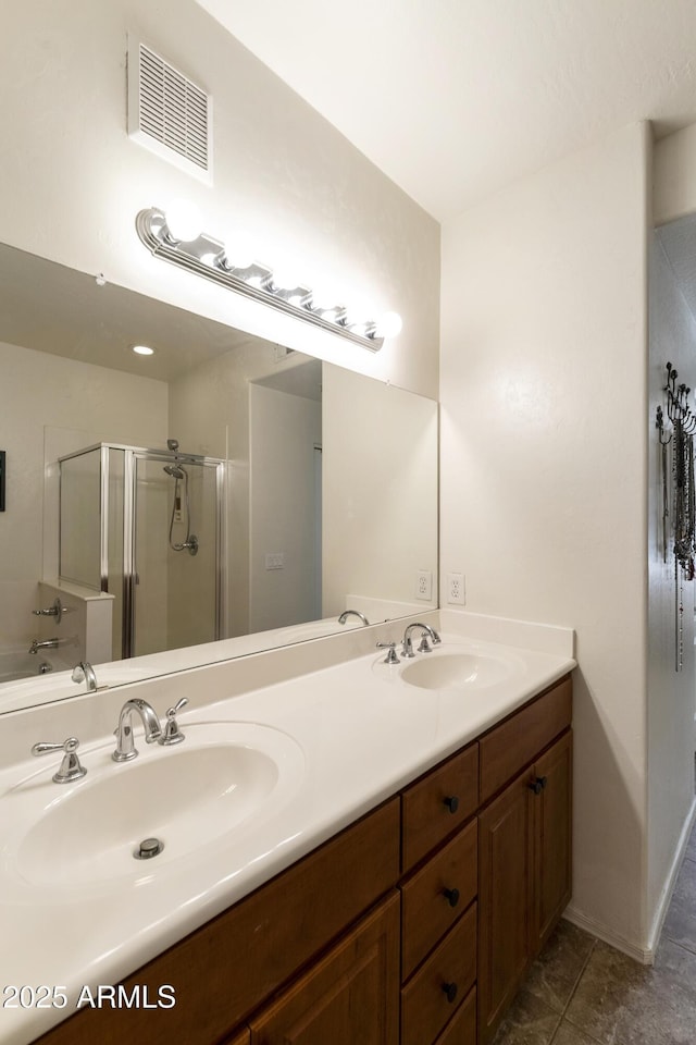 bathroom with vanity, an enclosed shower, and tile patterned flooring