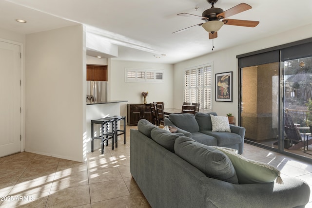 tiled living room featuring ceiling fan